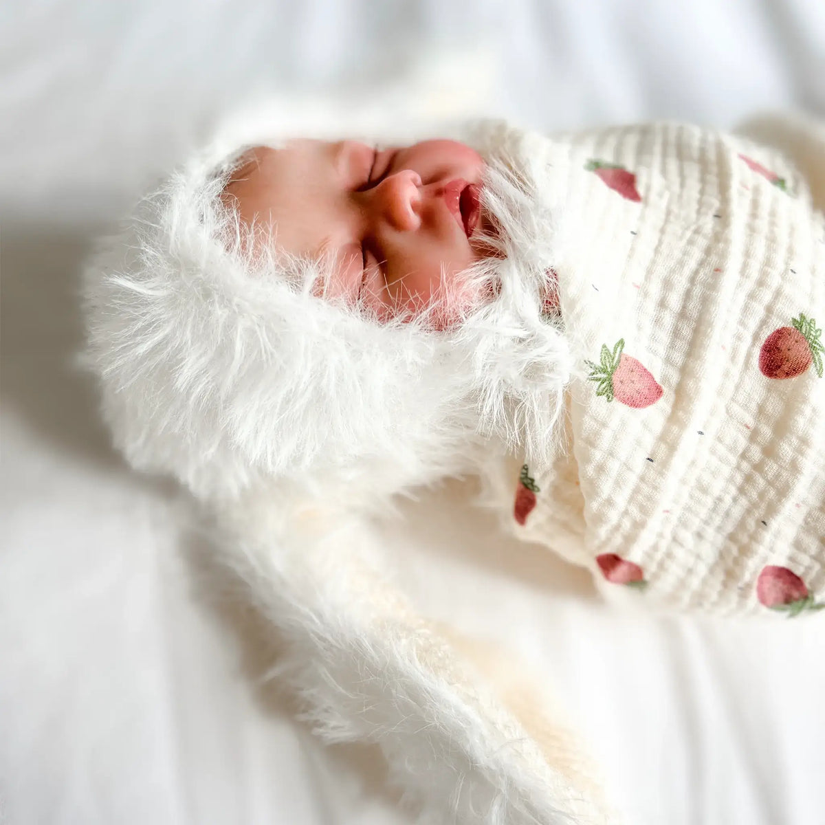 Cute muslin swaddle blanket with vibrant strawberry pattern