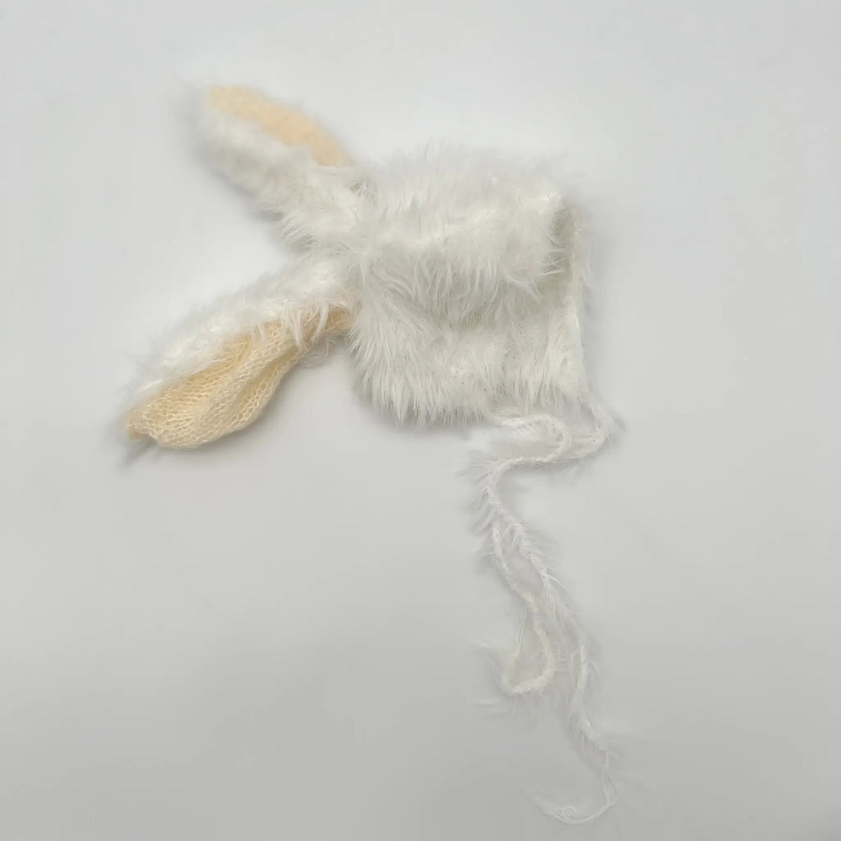 Plush white baby hat with bunny ears, perfect for Easter fun