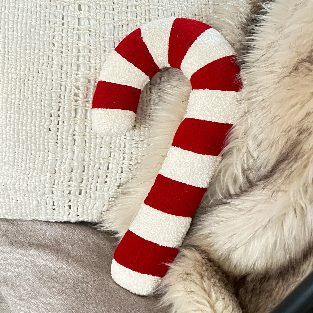 Holiday inspired candy cane decorative pillow in red and white stripes