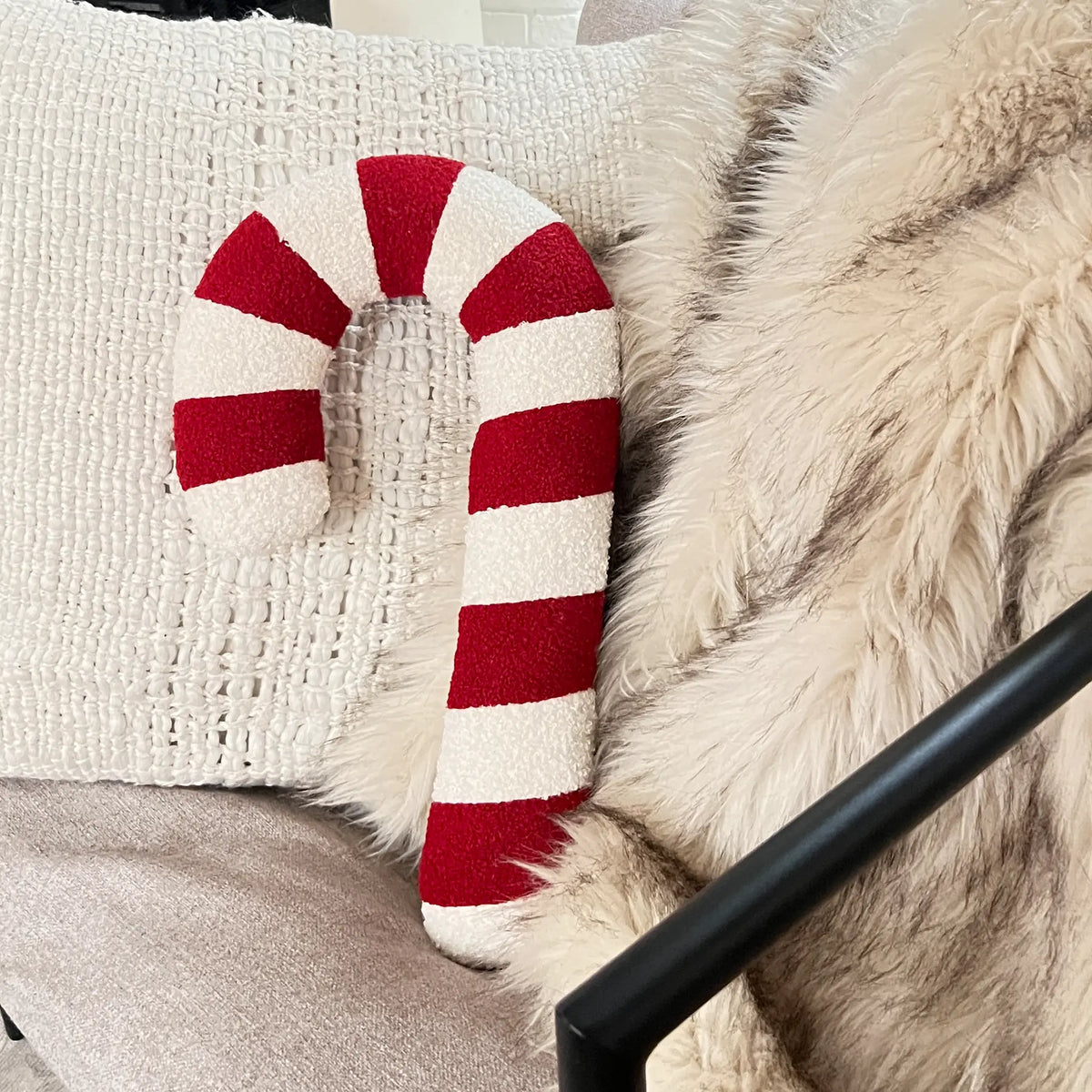 Holiday candy cane pillow on couch