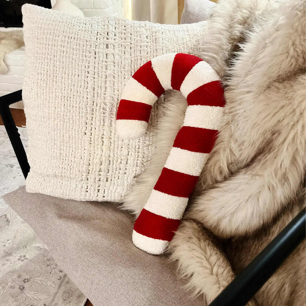 Red and white striped candy cane pillow for festive vibes