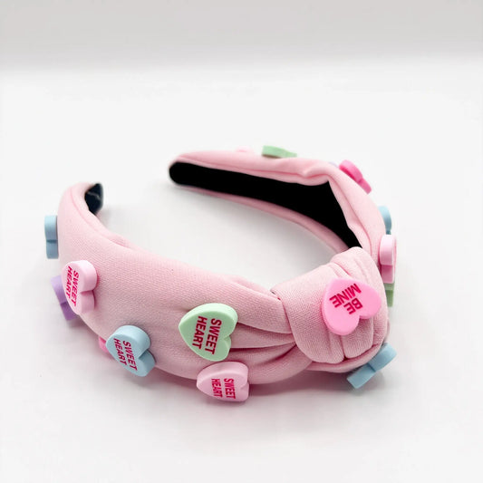 Adorable headband adorned with pink candy heart decorations.
