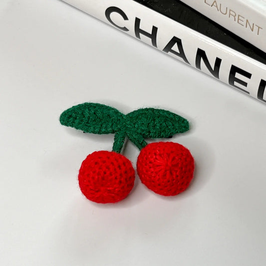 Adorable cherry-themed crochet hair accessories, perfect for a sweet look