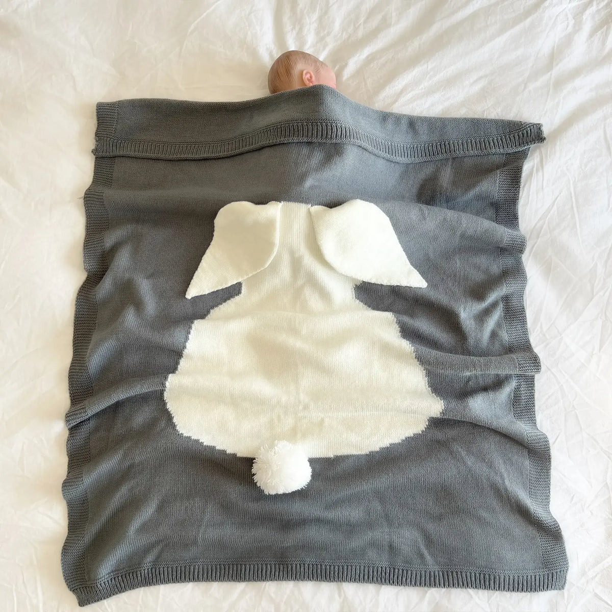 Experience the perfect blend of warmth and charm with our gray knit bunny blanket. Ideal for cuddling up on cooler days