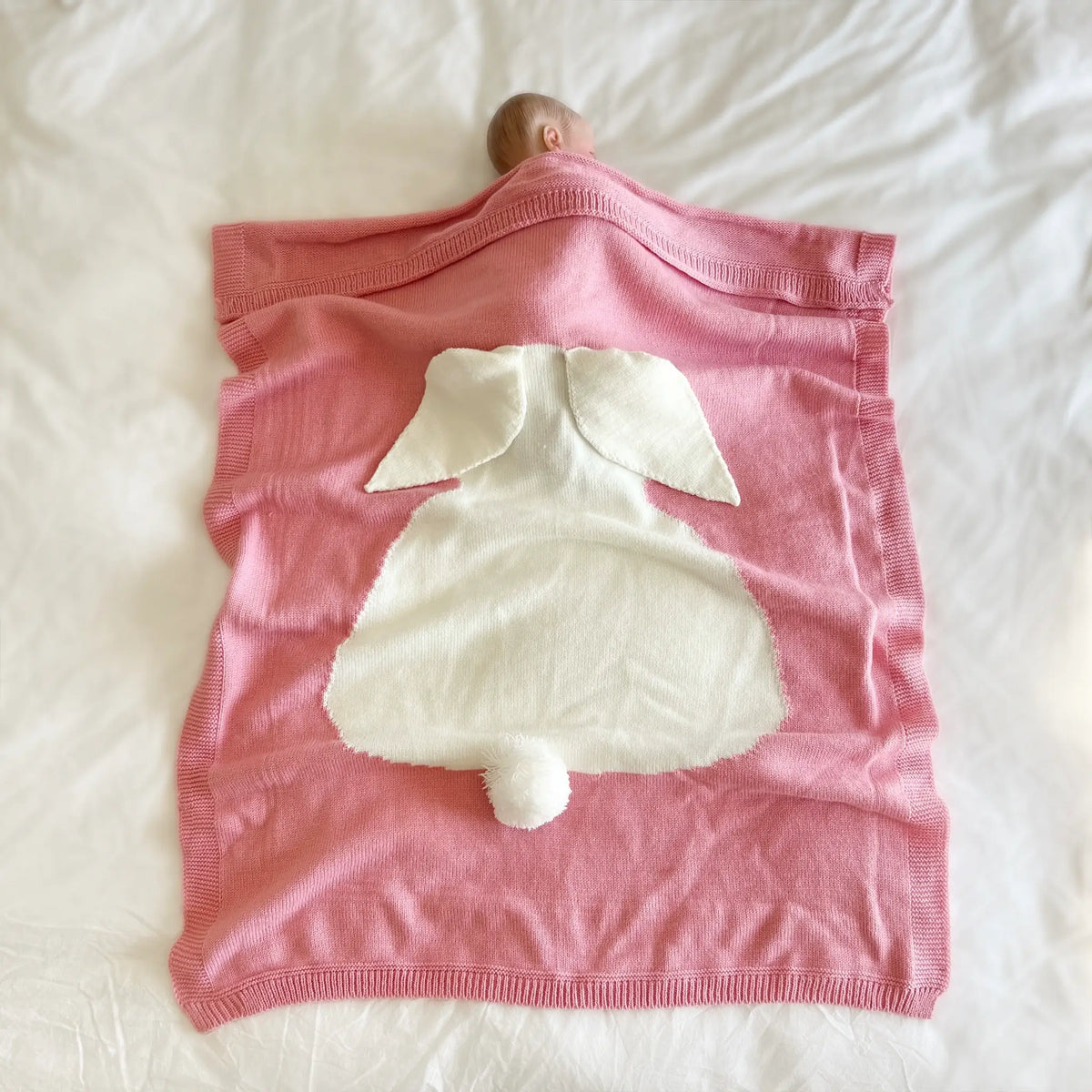 Indulge in comfort with our pink knit bunny blanket. Soft, cuddly, and irresistibly charming for cozy nights at home