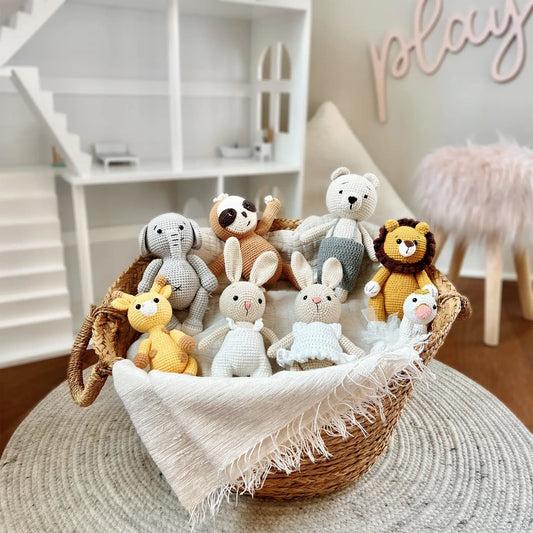 Handcrafted crochet animals arranged in a wicker basket