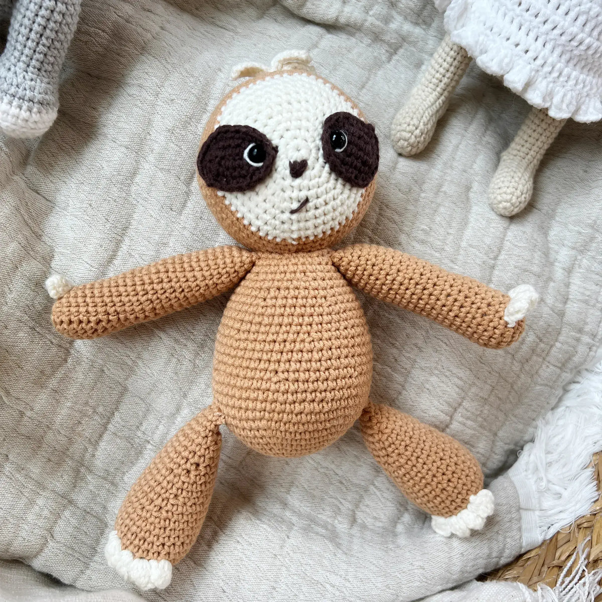 Crocheted sloth plushie with a lovable expression