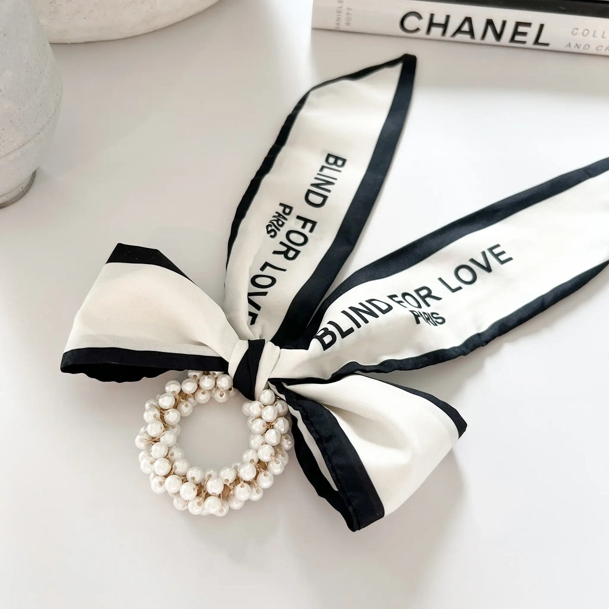 Pearl-studded hair adornment: French-inspired bow with lustrous pearls for a refined look
