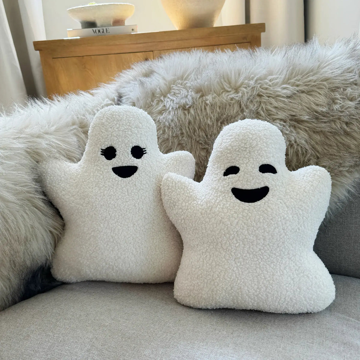 Sherpa girl and boy pillows sitting on couch