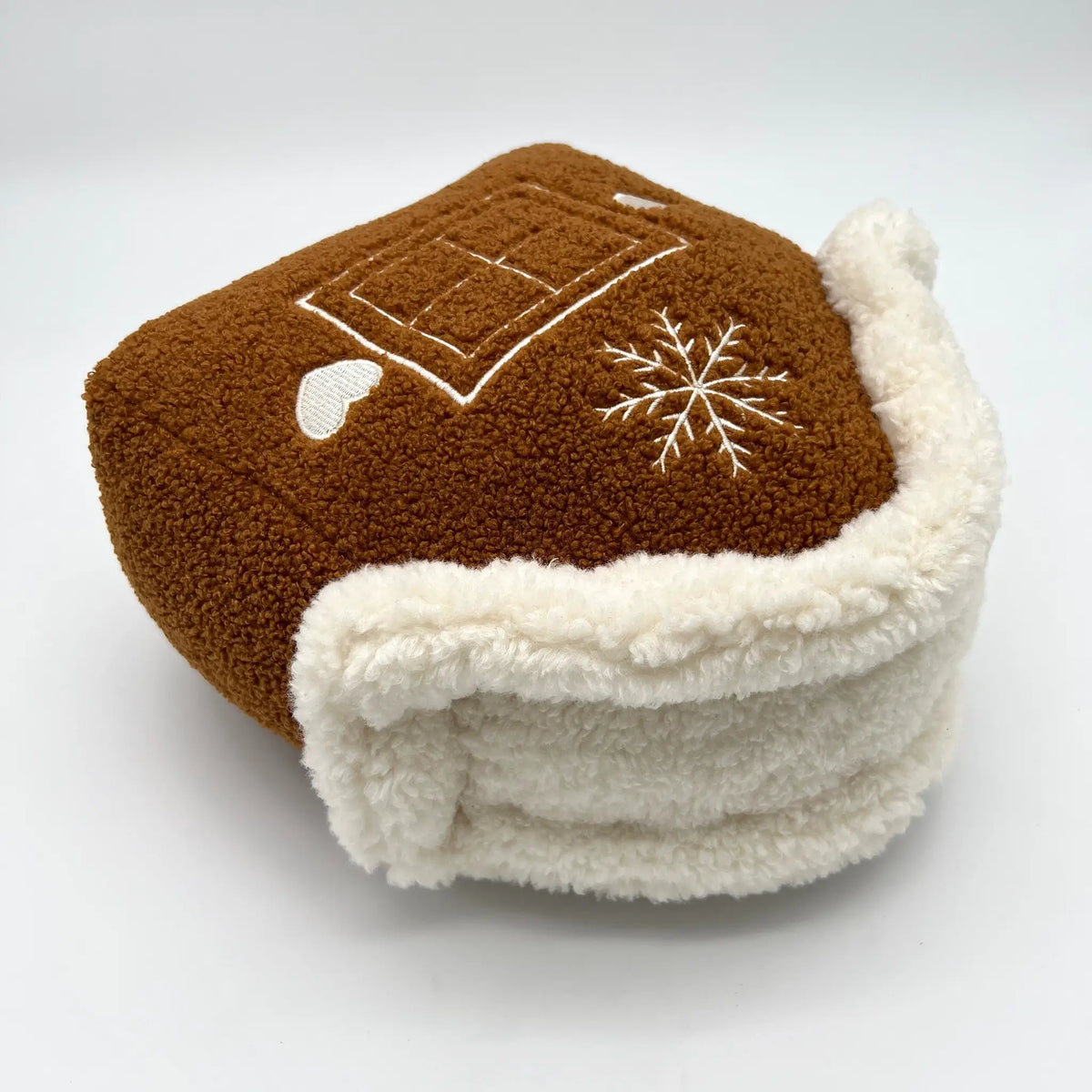 Decorative pillow shaped like a festive gingerbread house