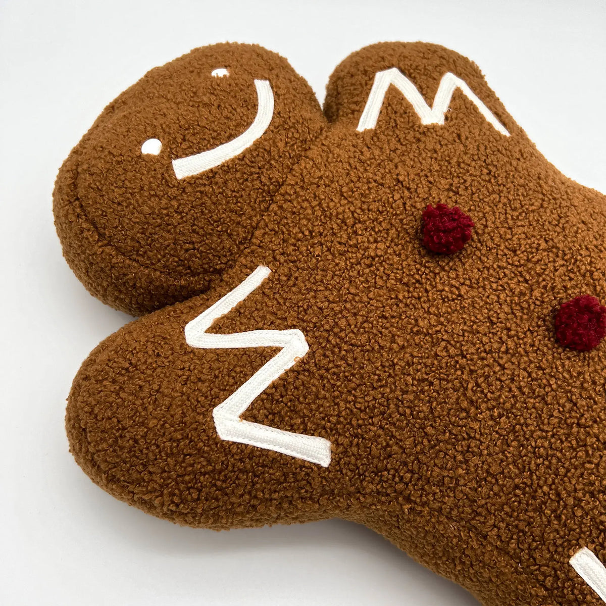 Cute gingerbread man pillow perfect for festive decorations