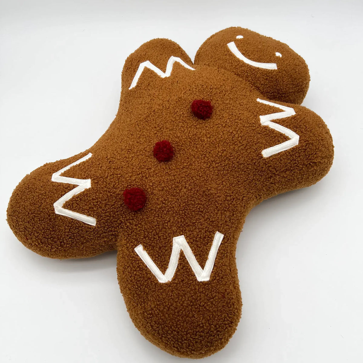 Adorable holiday pillow featuring a gingerbread man design