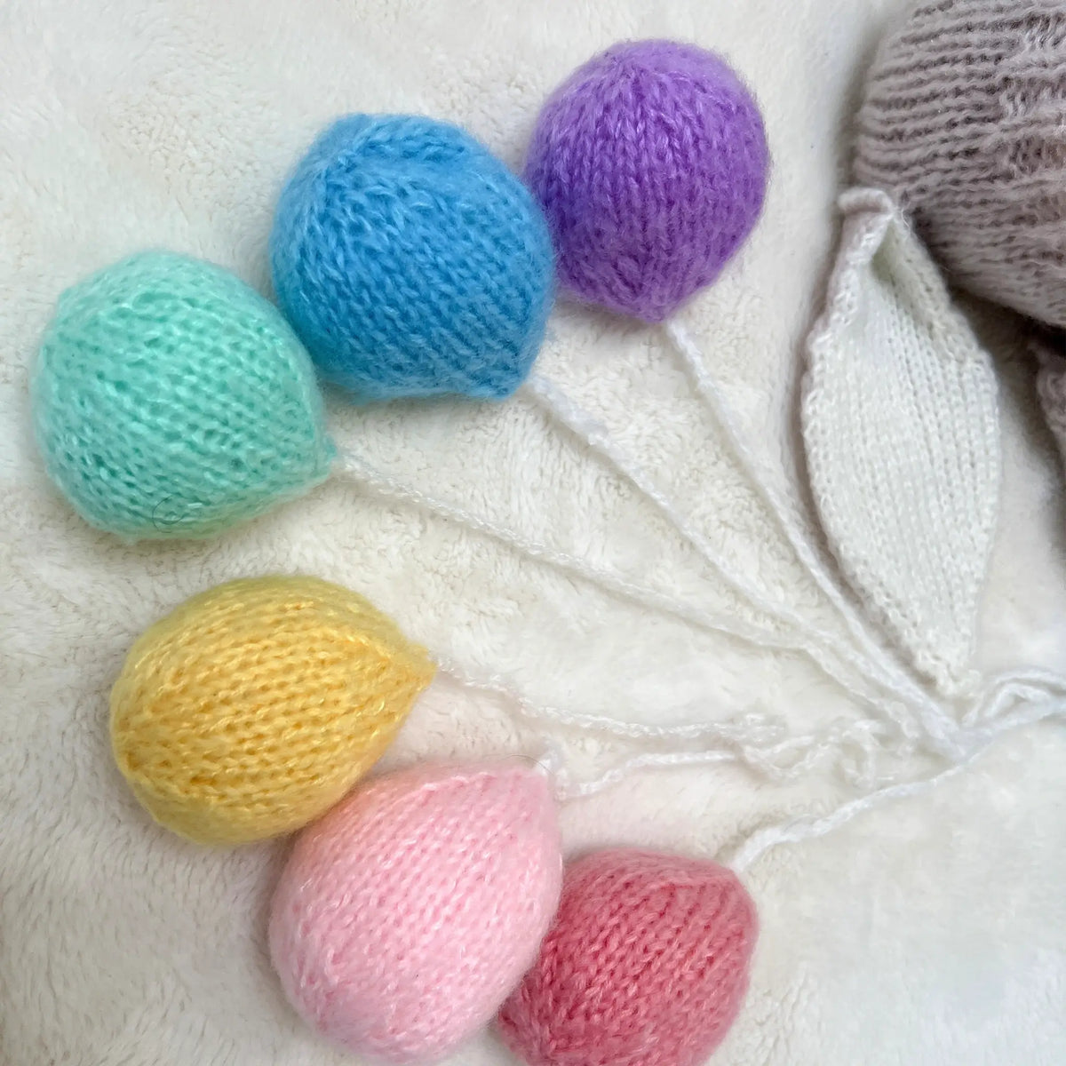Charming knit rainbow balloon prop for playful and vibrant photography