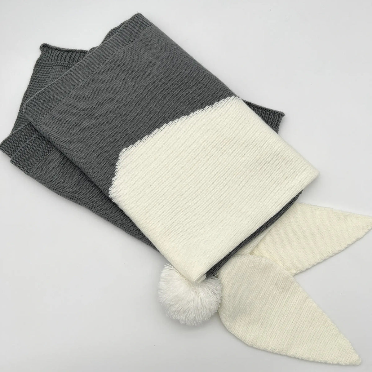 Add a touch of cozy charm to your space with our gray knit bunny blanket. Perfect for snuggling up and unwinding