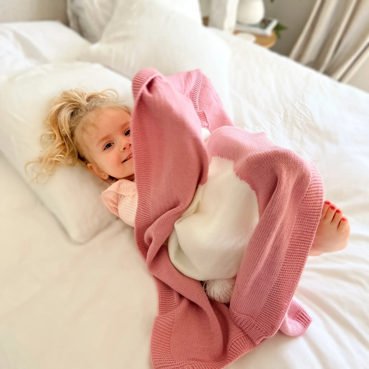 Experience coziness like never before with our pink knit bunny blanket