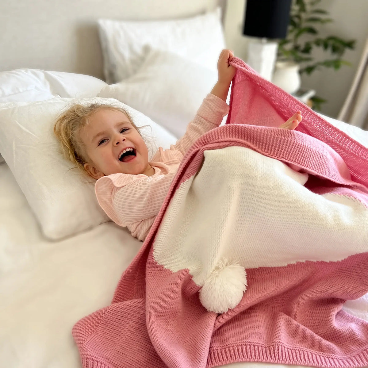 Snuggle up in style with our pink knit bunny blanket
