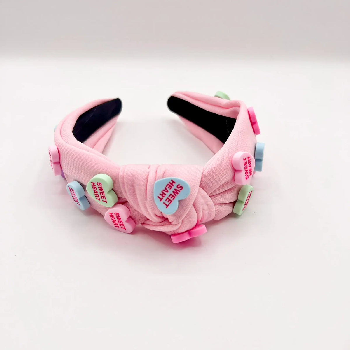 Fun and colorful pink candy hearts headband to add a touch of sweetness to your outfit.