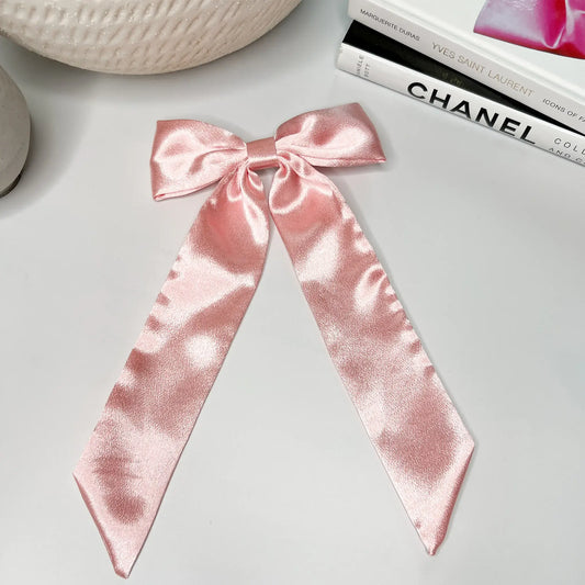 Pretty in pink: Satin hair bow, adding a pop of color to your hairstyle