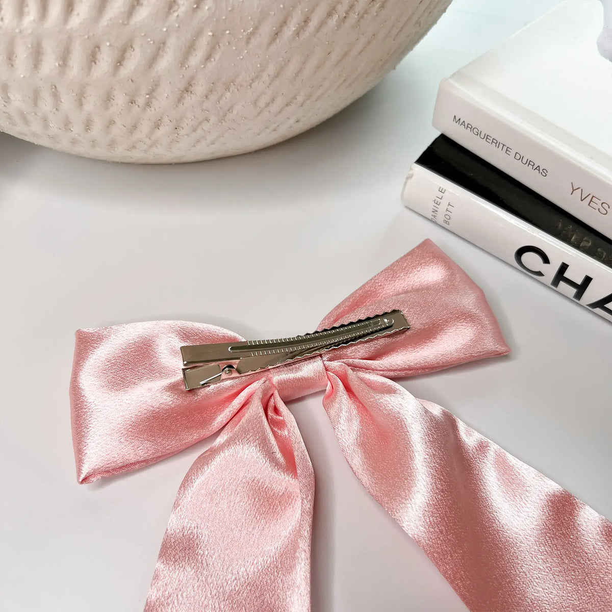 Girly glam: Satin hair bow in blush pink, a versatile accessory for any occasion