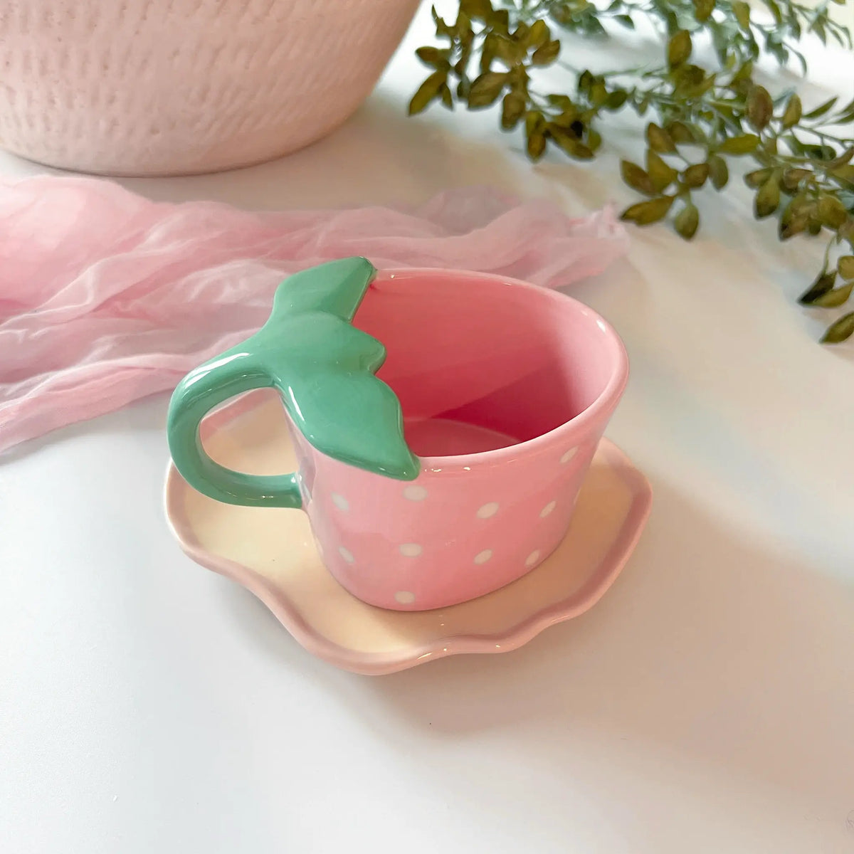Pink ceramic mug and saucer featuring cute strawberry designs