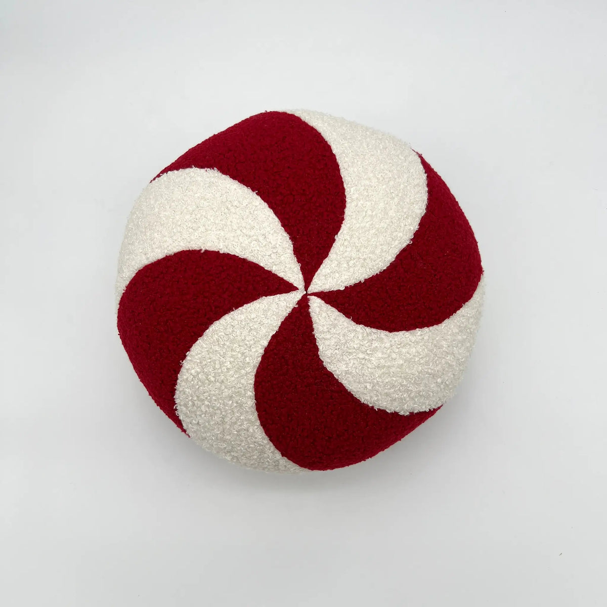 Charming holiday throw pillow with round peppermint design