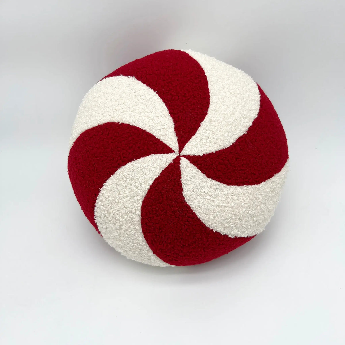 Round peppermint Christmas pillow for festive holiday decor