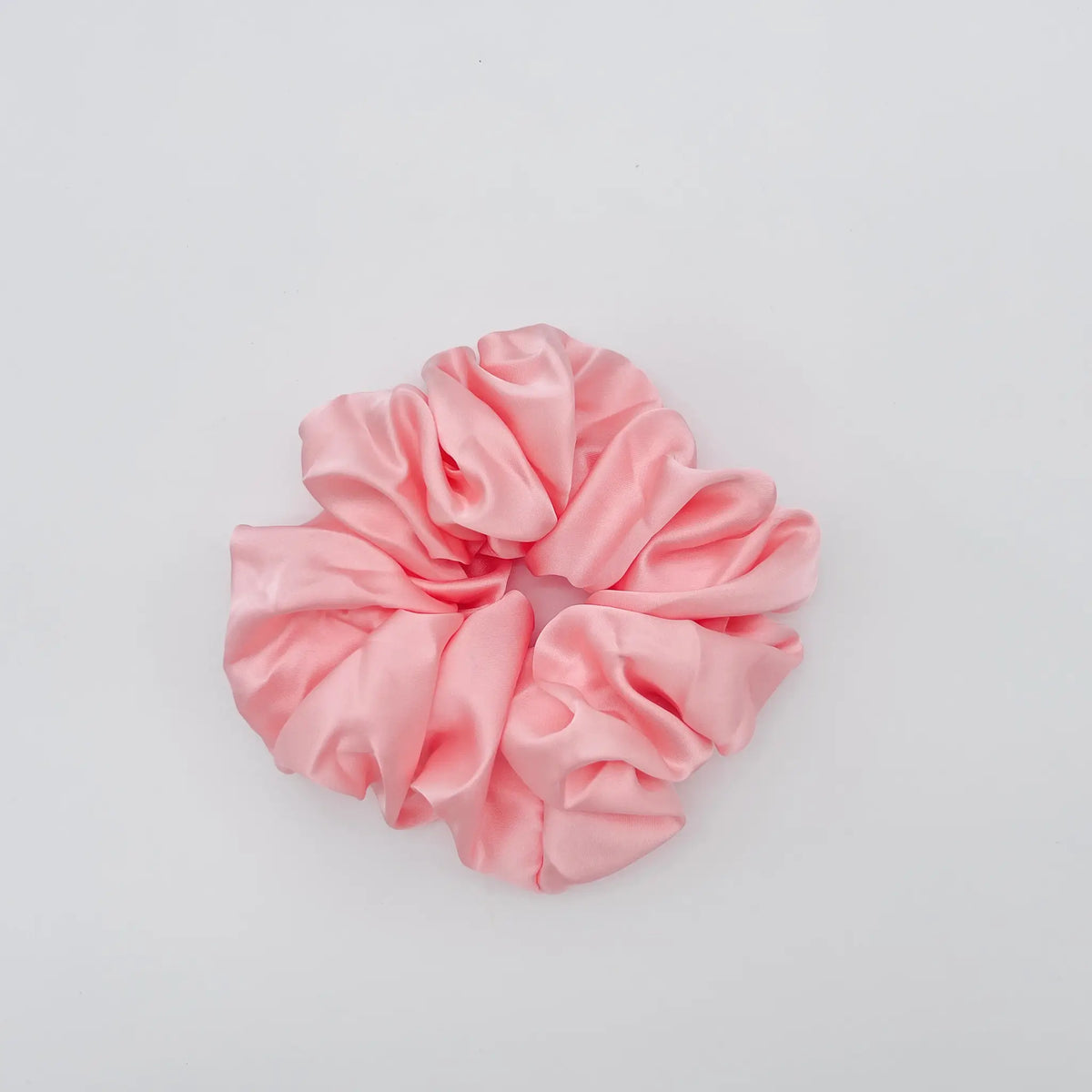 Stylish pink scrunchie adds flair to any outfit