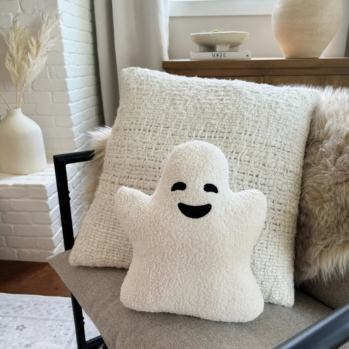 Smiling ghost pillow sitting on couch