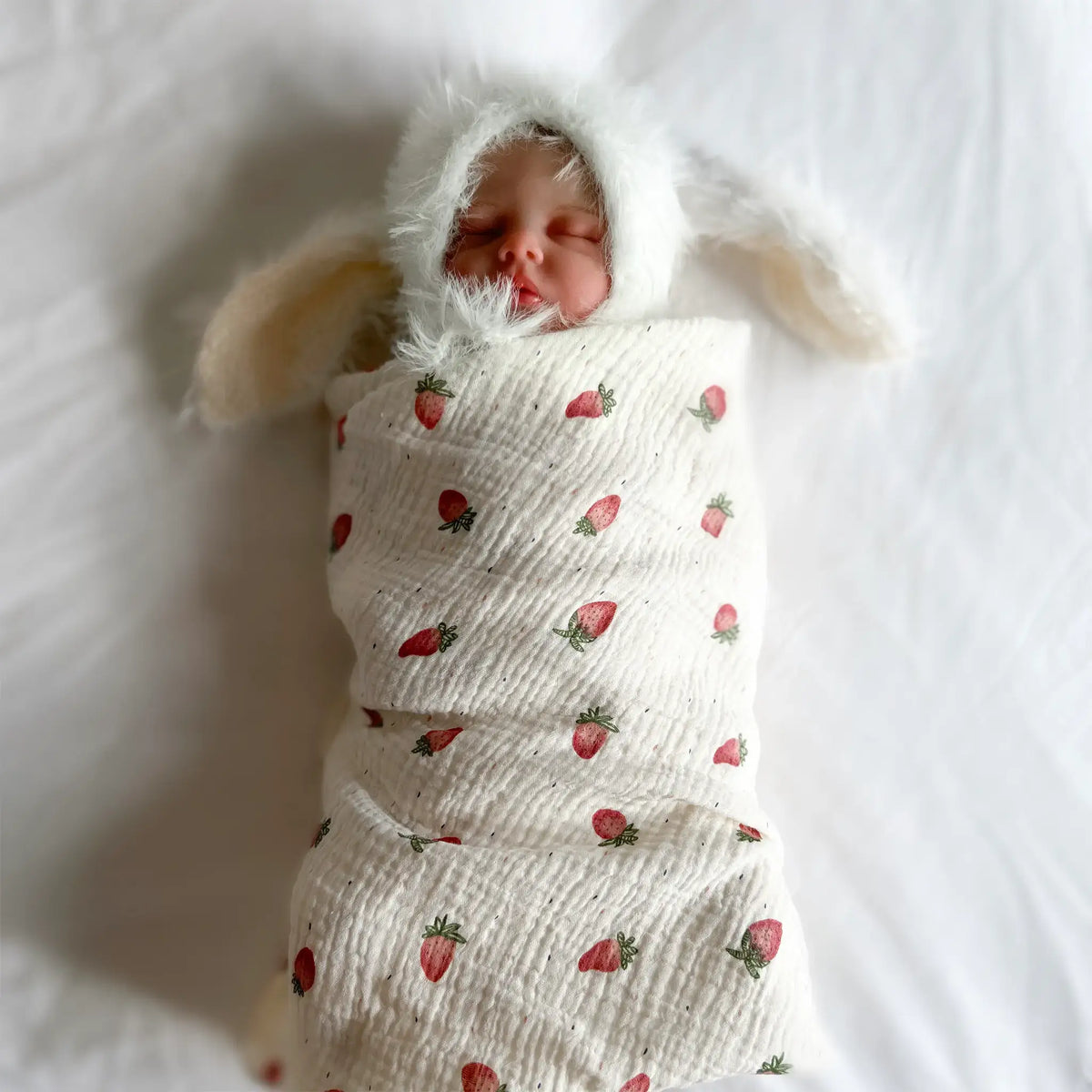 Charming strawberry muslin swaddle perfect for newborns