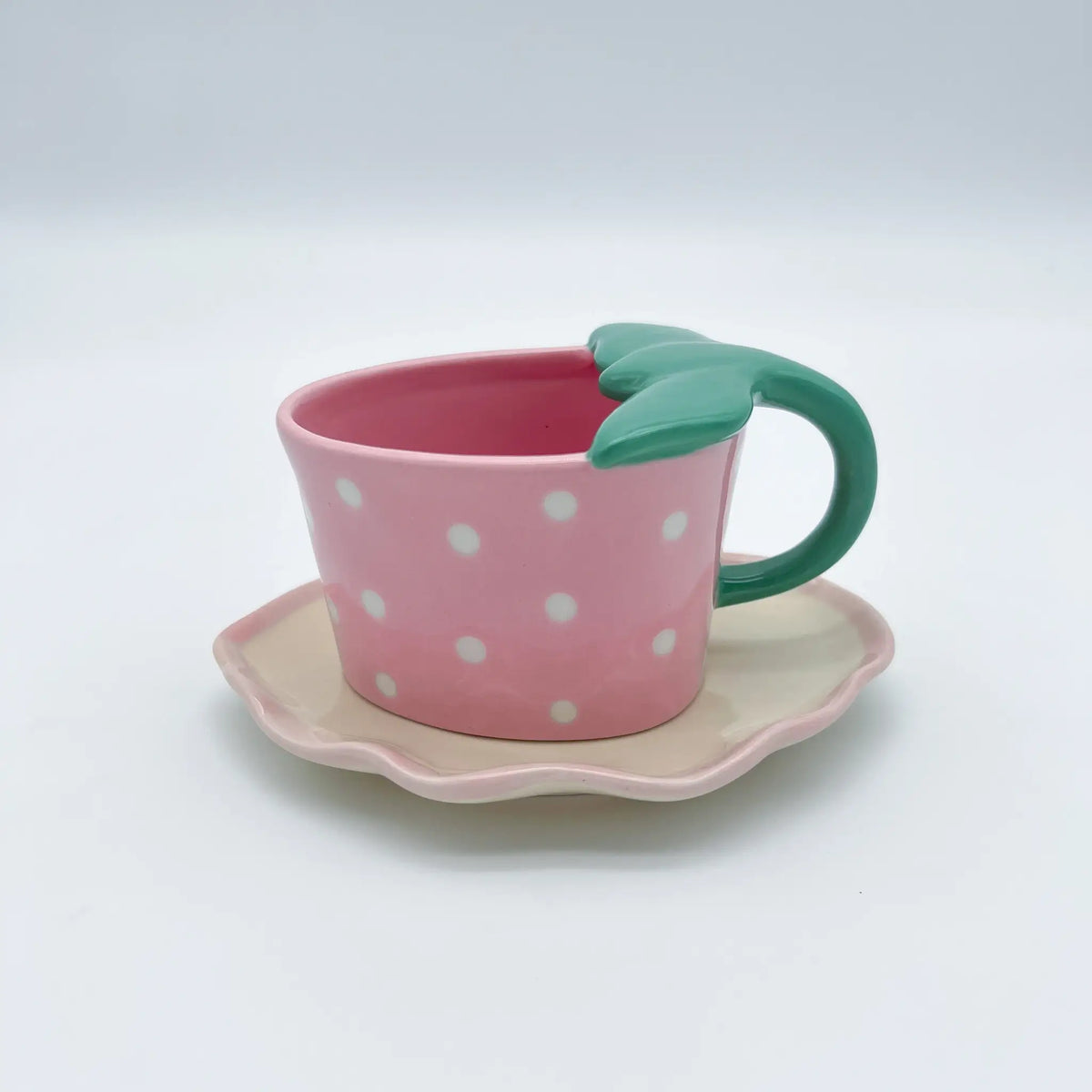 Pink strawberry mug with a lovely leaf shaped handle and saucer
