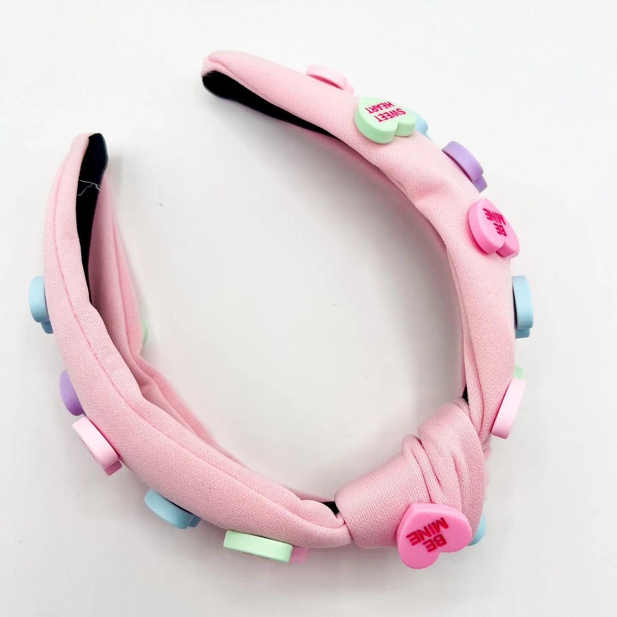 Adorable pink candy hearts headband: Sweet accessory for any occasion.