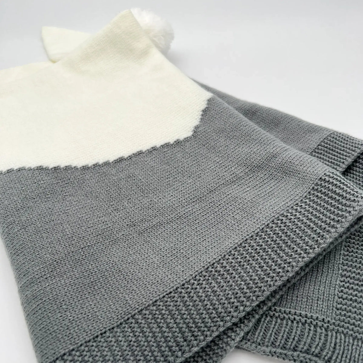 Snuggle up in style with our cozy gray knit bunny blanket.
