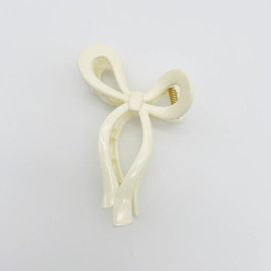 White bow shaped hair clip for feminine flair.